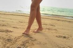 Feet walking on sand