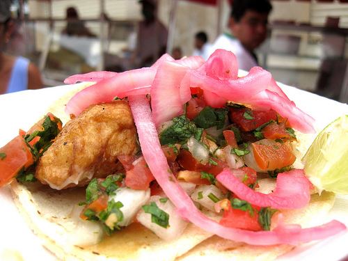 Taco cart fish taco with pickled onions
