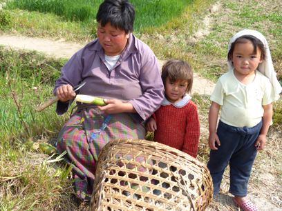 Bhutanese mother and children in the fields