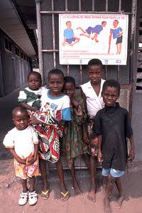 African Kids Near a Polio Sign