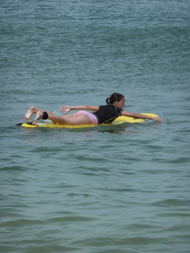 Girl Surfer paddling out