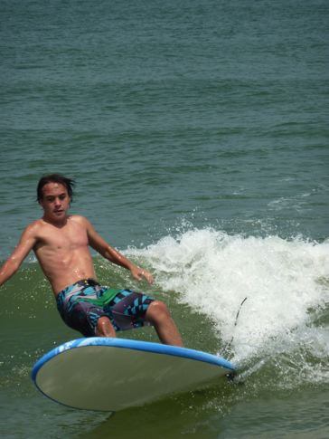 Young Surfer Rides a Wave