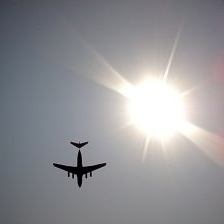 Airplane flies by sun - Holiday Airfares Up, How To Save