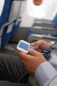 cell phone on a plane, image credit BigStock