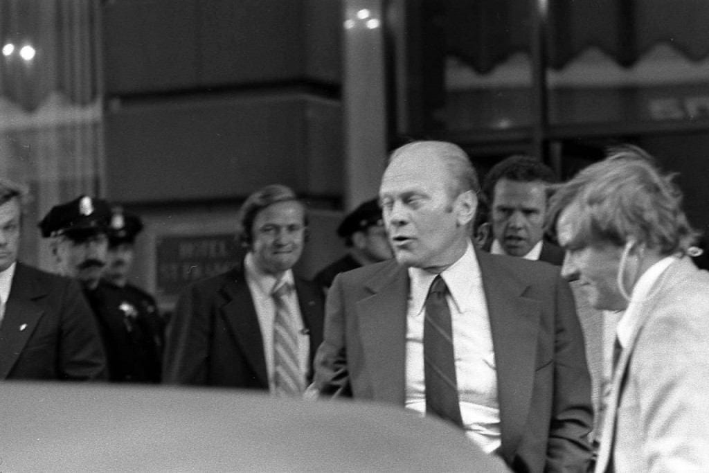 President Gerald Ford wincing at the sound of the gun fired by Sara Jane Moore during the assassination attempt in San Francisco, California.